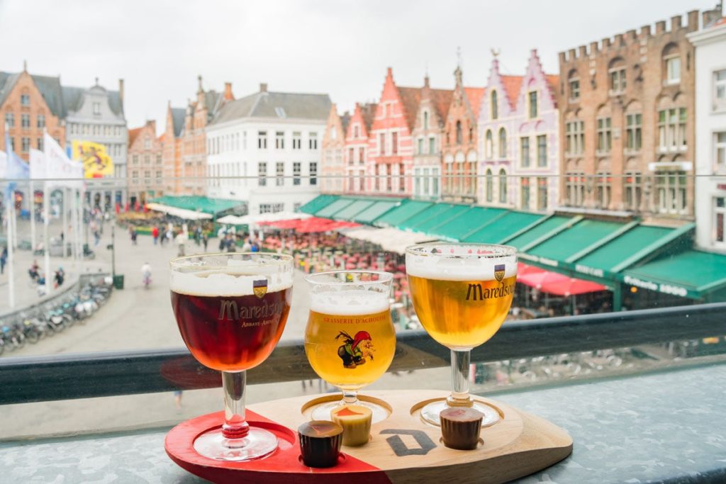 Enjoying beer and chocolate at Market Place in Brugge, Belgium