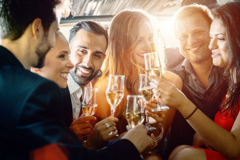 birthday party in a limo with glasses of champagne