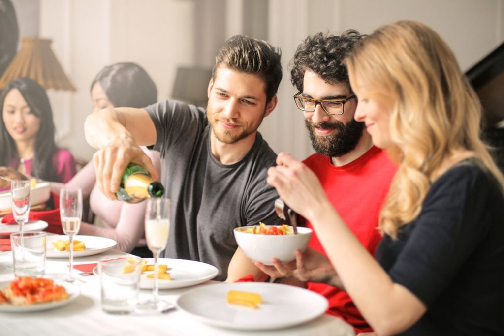 friends having dinner and champagne together