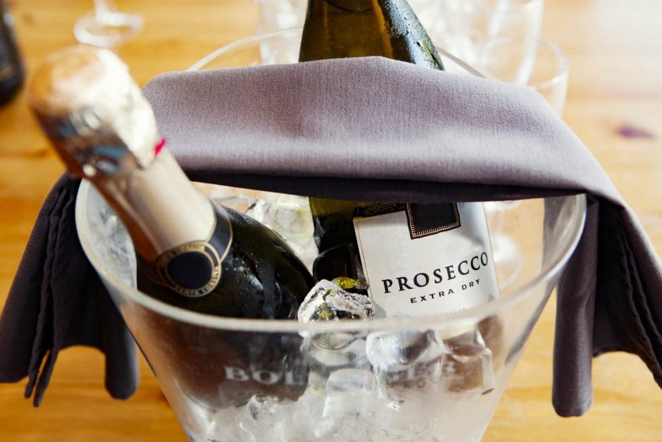 Prosecco bottles over ice in an ice bucket